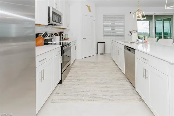 a kitchen with stainless steel appliances a stove and more cabinets
