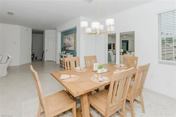 a view of a dining room with furniture and chandelier