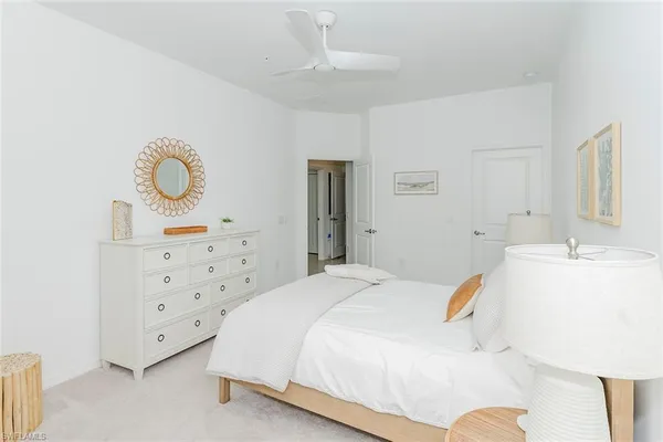 a spacious bedroom with a bed and a cabinets
