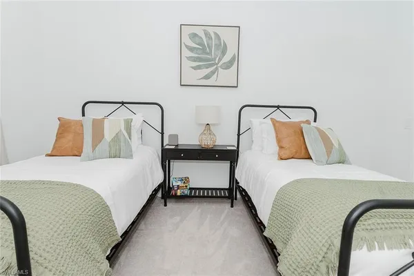 a bedroom with a bed and painting on the wall