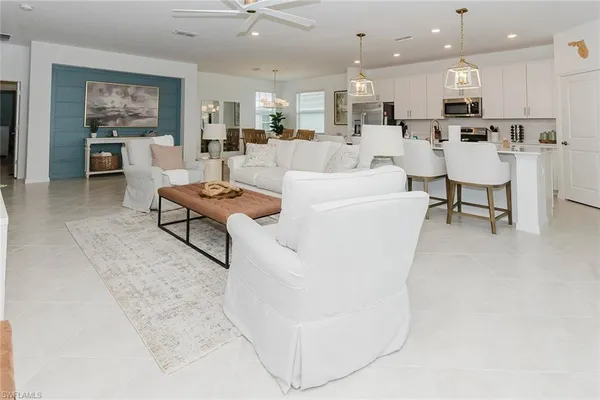 a living room with furniture and kitchen view