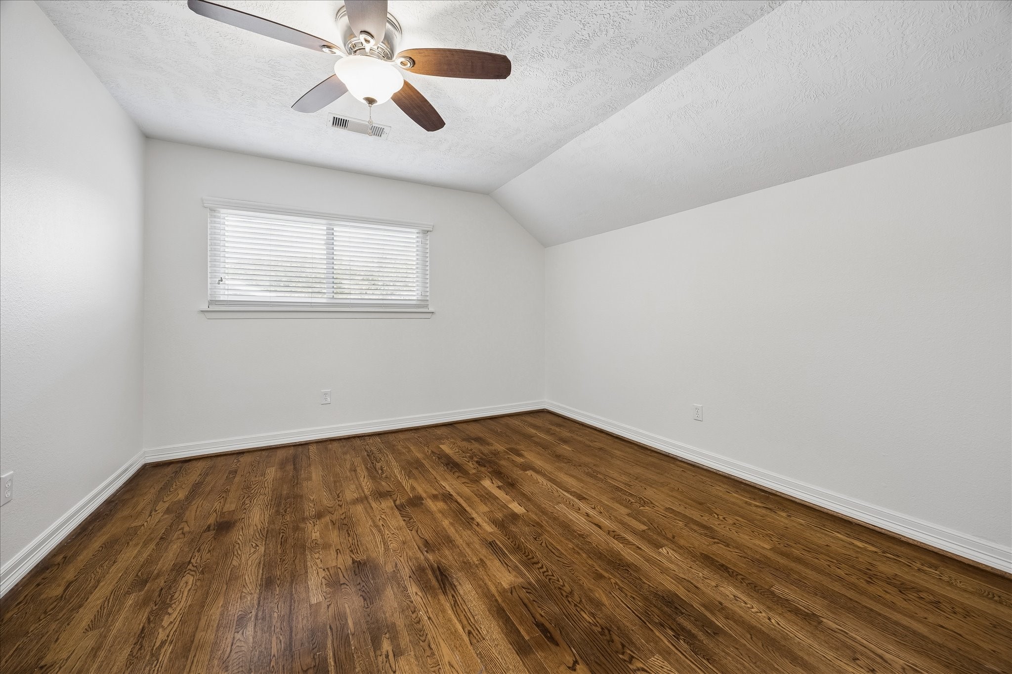 5019 Kinglet Street Houston, TX 77035 - Photo 17 of 24 One of two second floor secondary bedrooms boasting gleaming hardwood floors (no carpet in house!), ceiling fans, upgraded windows & spacious closets.