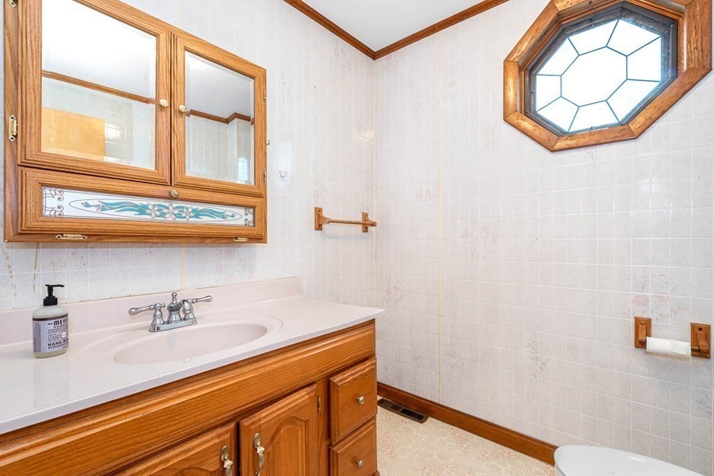 101 Reed Street Cambridge, MA 02140 - Photo 14 of 15 a bathroom with a sink and a mirror