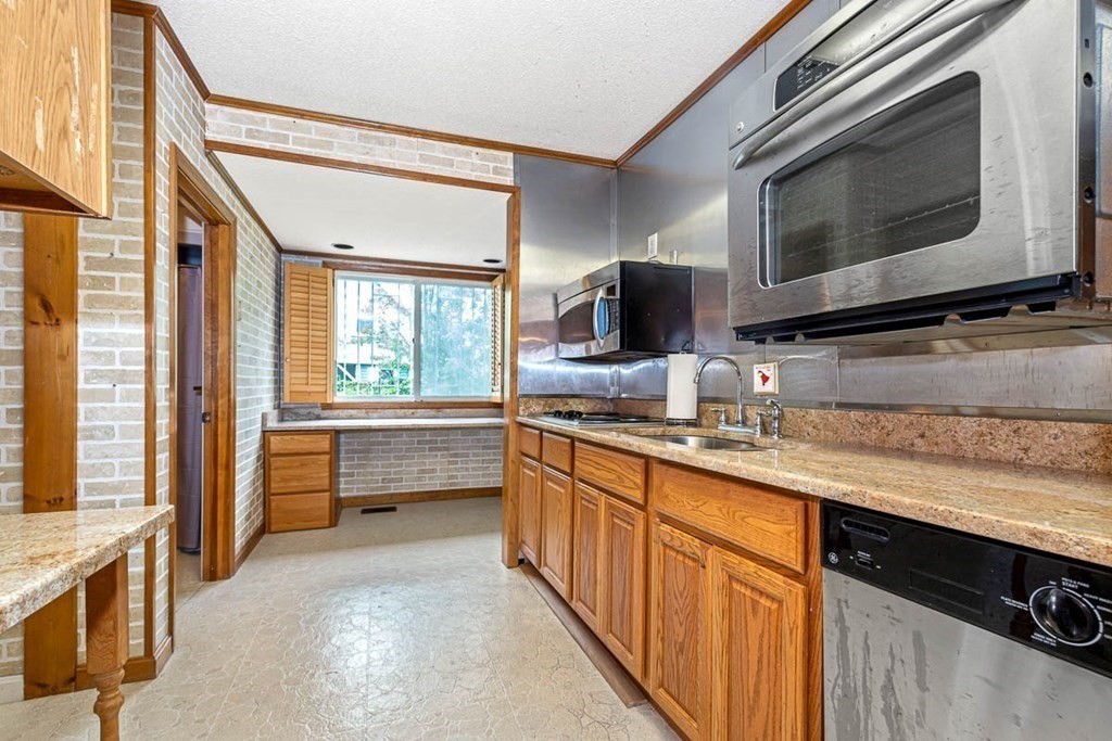 101 Reed Street Cambridge, MA 02140 - Photo 8 of 15 a kitchen with stainless steel appliances a stove sink and microwave