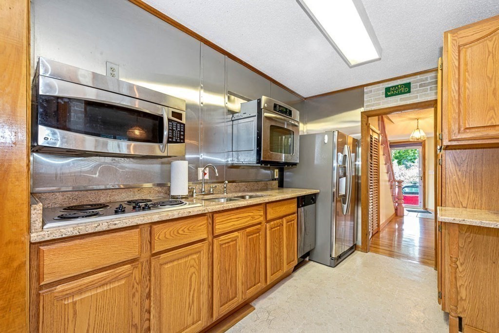 101 Reed Street Cambridge, MA 02140 - Photo 9 of 15 a kitchen with stainless steel appliances granite countertop a stove a sink and a refrigerator