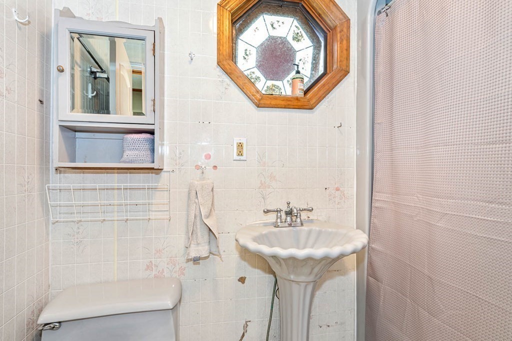 101 Reed Street Cambridge, MA 02140 - Photo 10 of 15 a bathroom with a sink and a mirror