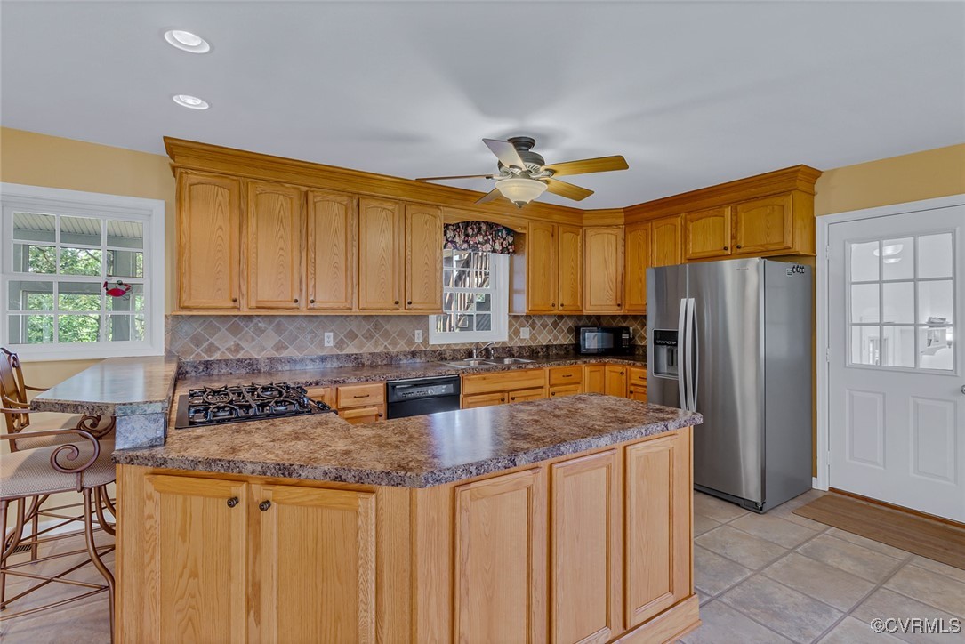 781 Coan Haven Road Lottsburg, VA 22511 - Photo 17 of 50 a kitchen with stainless steel appliances granite countertop a sink a stove cabinets and a refrigerator