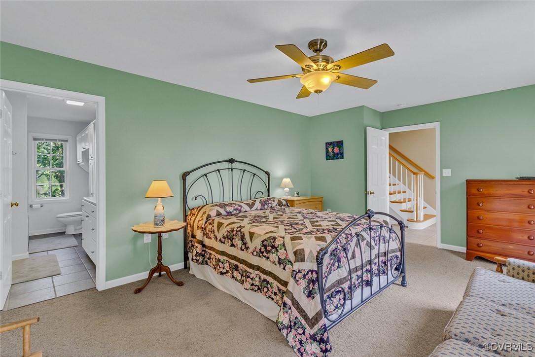 781 Coan Haven Road Lottsburg, VA 22511 - Photo 24 of 50 a bedroom with a bed a chandelier and a dresser