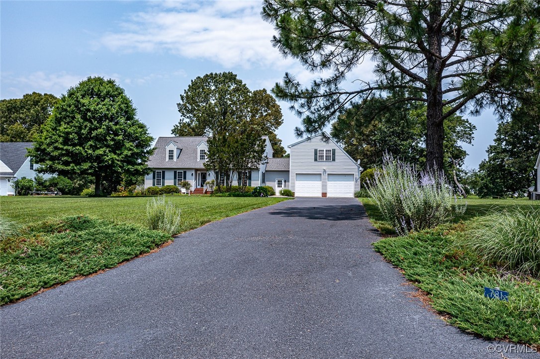 781 Coan Haven Road Lottsburg, VA 22511 - Photo 44 of 50 a view of a house with a small yard and large trees