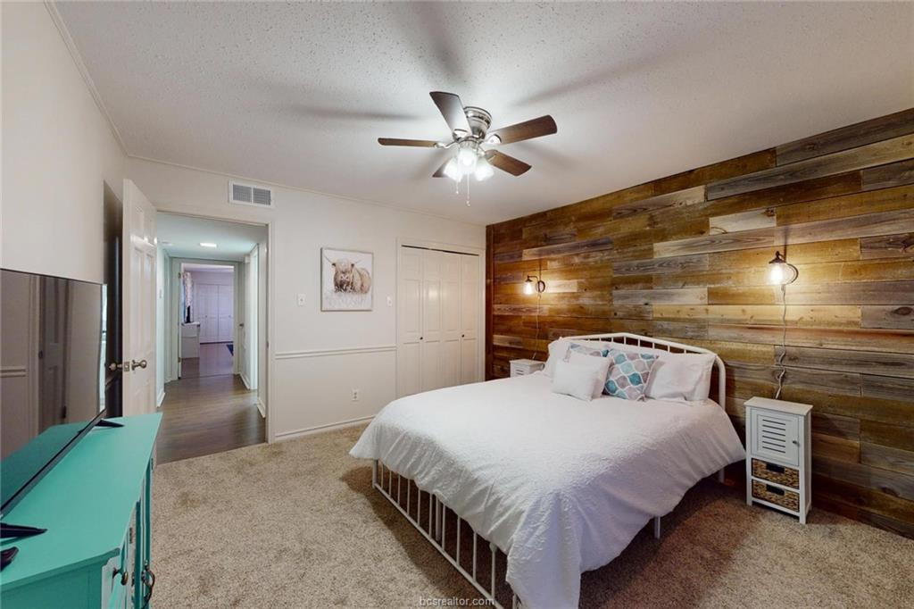 900 Westview Street Bryan, TX 77802 - Photo 20 of 30 a bedroom with a bed and a chandelier