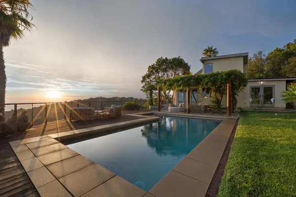 a view of swimming pool with outdoor seating and yard
