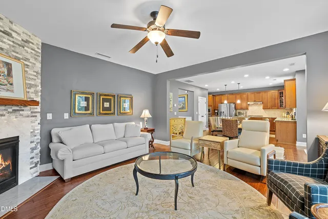 a living room with furniture and a chandelier