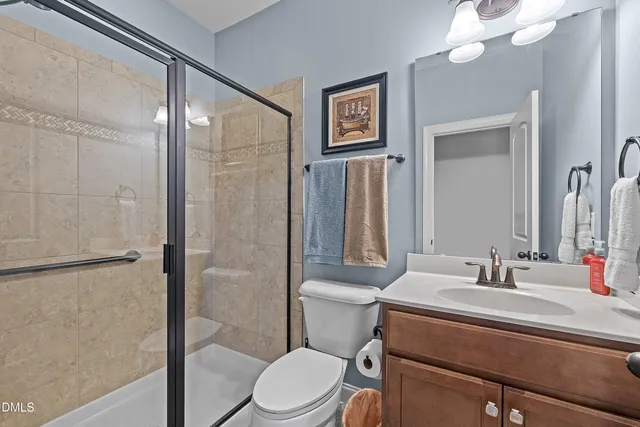 a bathroom with a tub a sink double vanity and a mirror