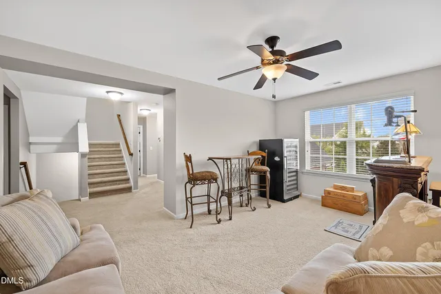 a living room with furniture a window and a flat screen tv
