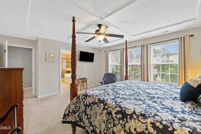 a bath room with a toilet a sink and a large mirror