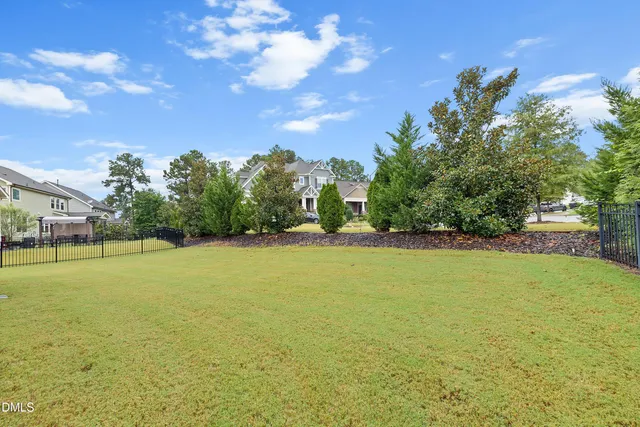 an aerial view of a residential houses with outdoor space and street view