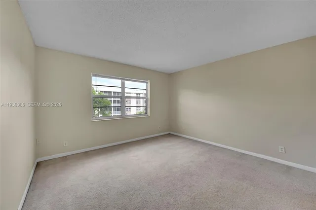 a view of an empty room and closet area