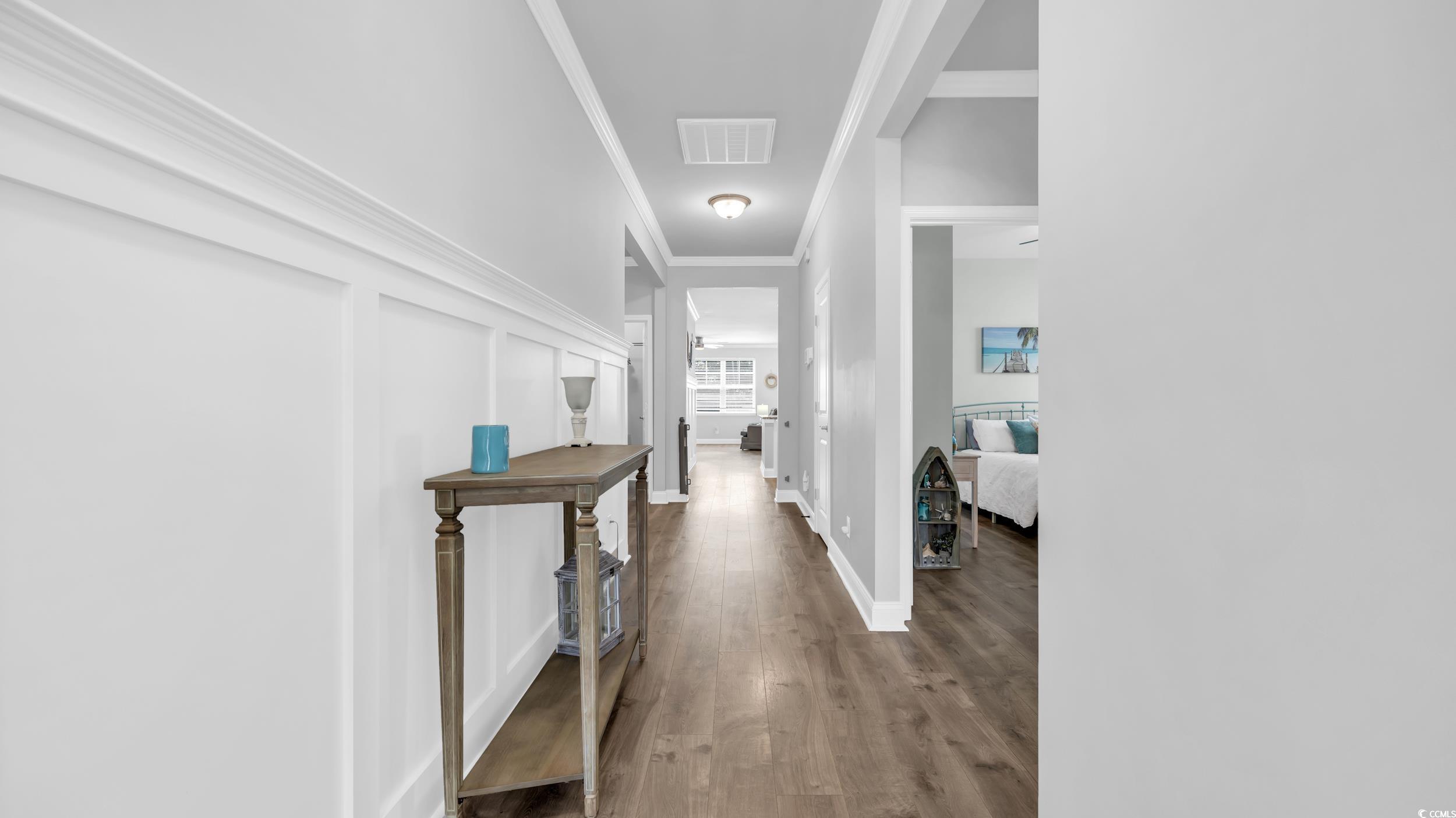 1102 Inlet View Drive North Myrtle Beach, SC 29582 - Photo 7 of 33 Hallway featuring wood finished floors and ornamental molding