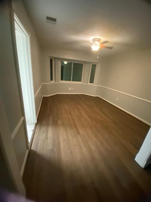 5710 Glenmere Lane Spring, TX 77379 - Photo 4 of 9 a view of an empty room with wooden floor and a window