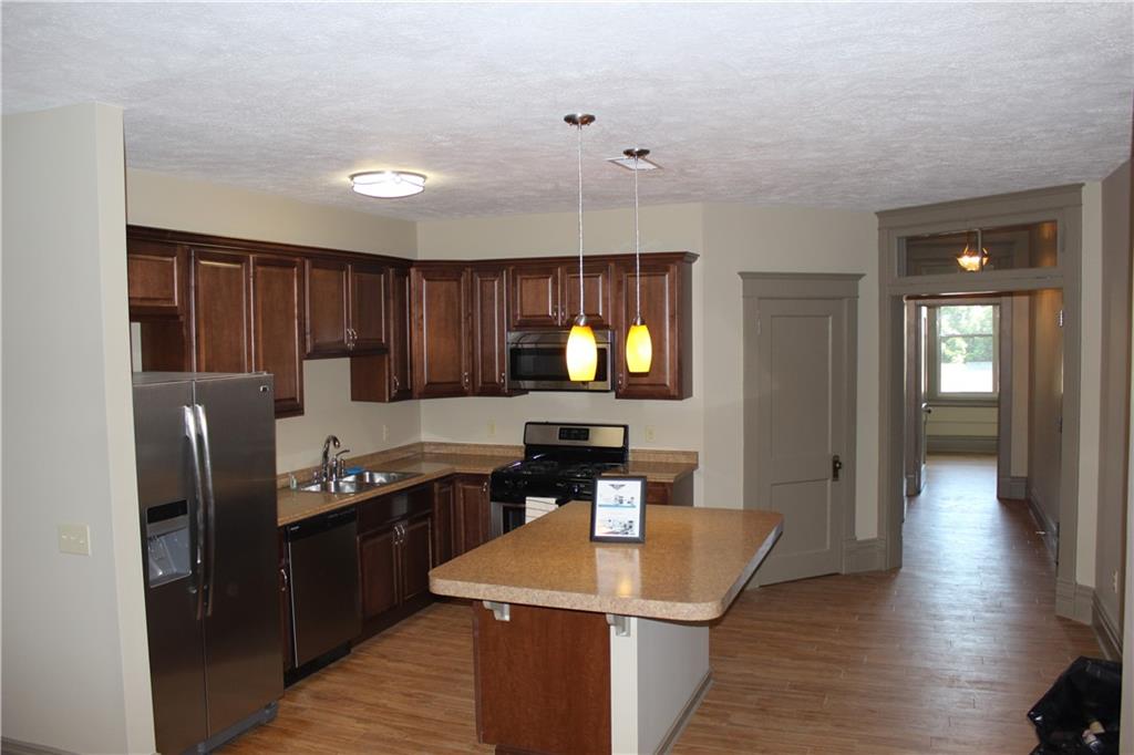 115 West Jefferson Street Butler, PA 16001 - Photo 22 of 30 a kitchen with granite countertop a sink cabinets and stainless steel appliances