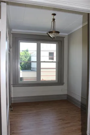 a view of a room with wooden floor and windows