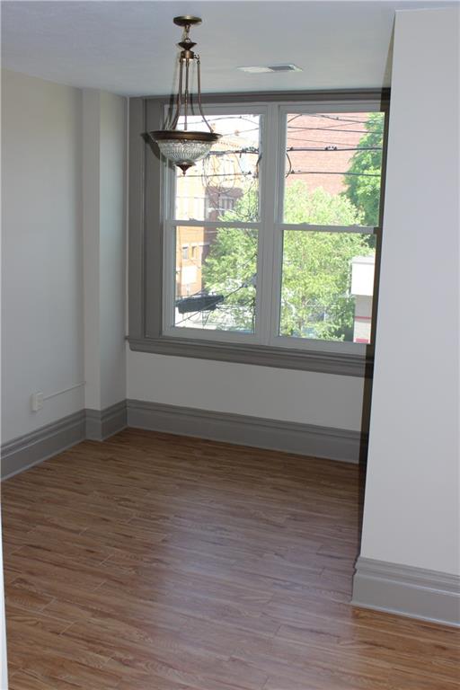 115 West Jefferson Street Butler, PA 16001 - Photo 26 of 30 a view of an empty room with wooden floor and a window