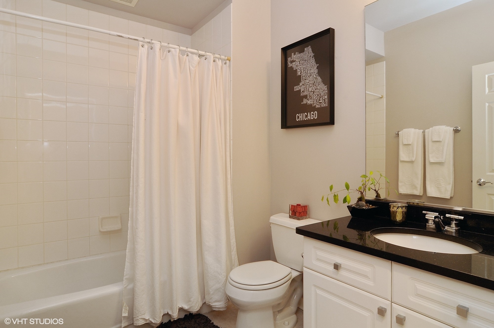 1122 North Dearborn Street, Unit 7A Chicago, IL 60610 - Photo 15 of 25 a bathroom with a granite countertop sink a toilet and a mirror