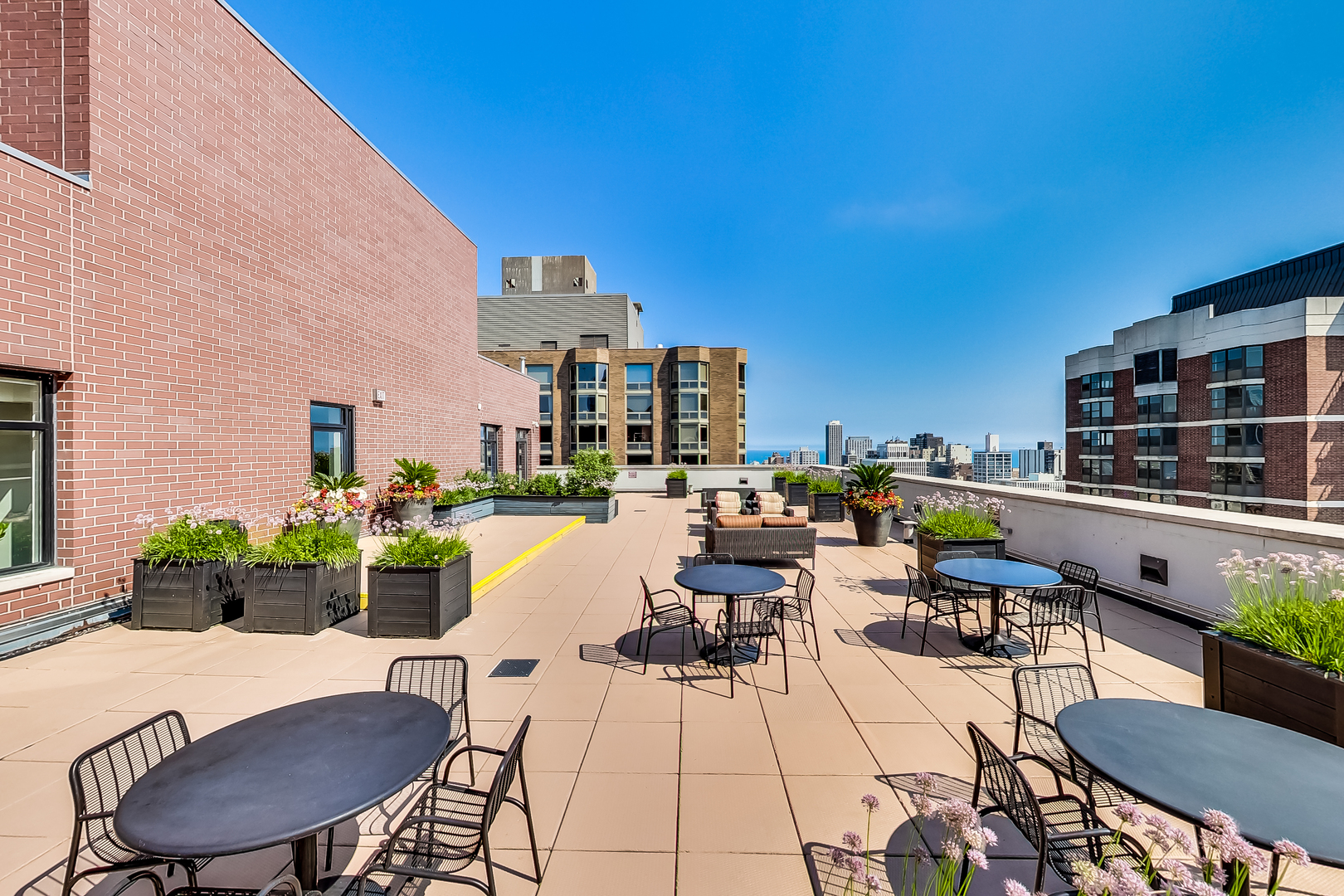 1122 North Dearborn Street, Unit 7A Chicago, IL 60610 - Photo 20 of 25 a view of a rooftop deck with chairs and tables