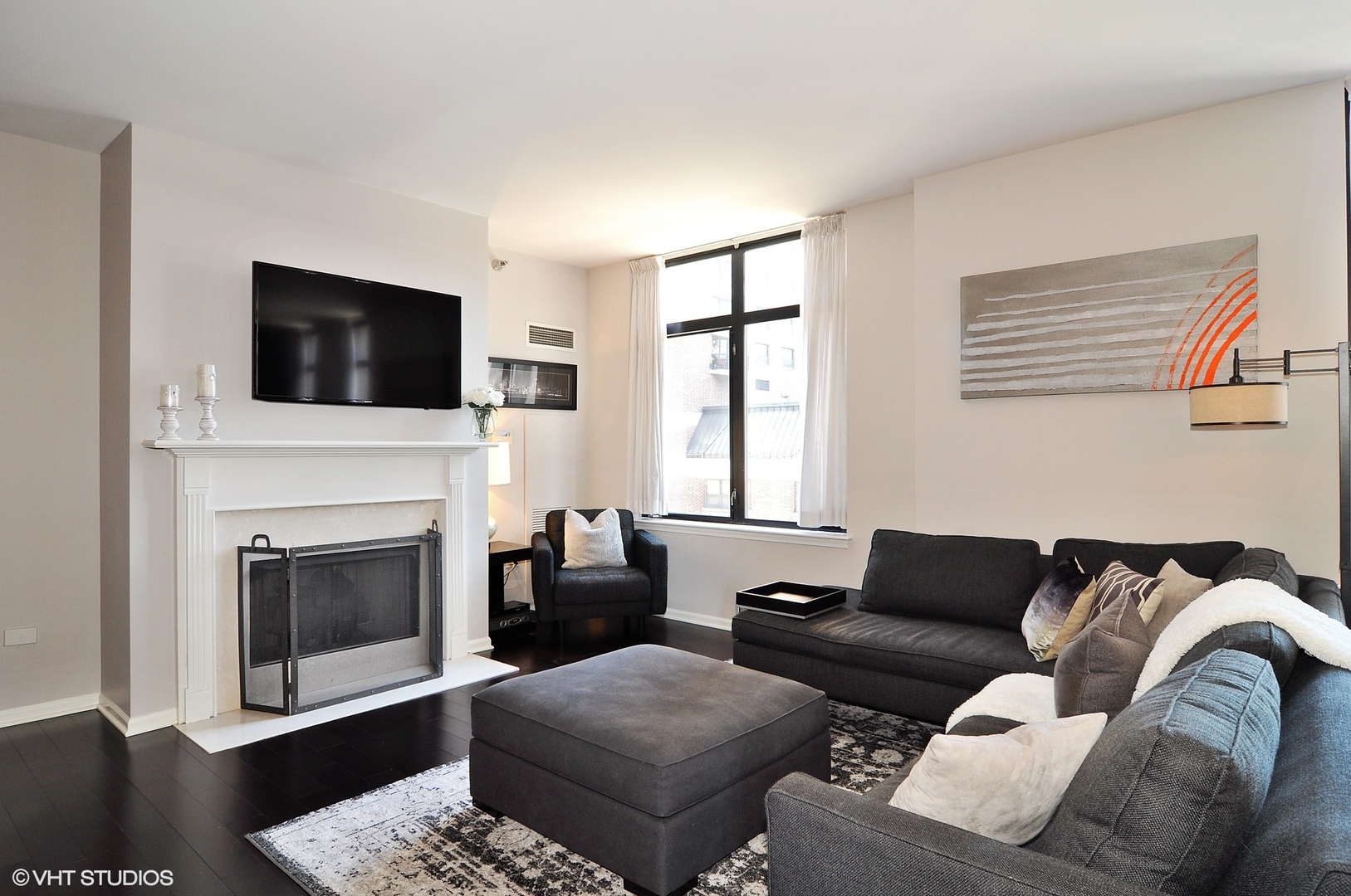1122 North Dearborn Street, Unit 7A Chicago, IL 60610 - Photo 5 of 25 a living room with furniture a flat screen tv and a fireplace