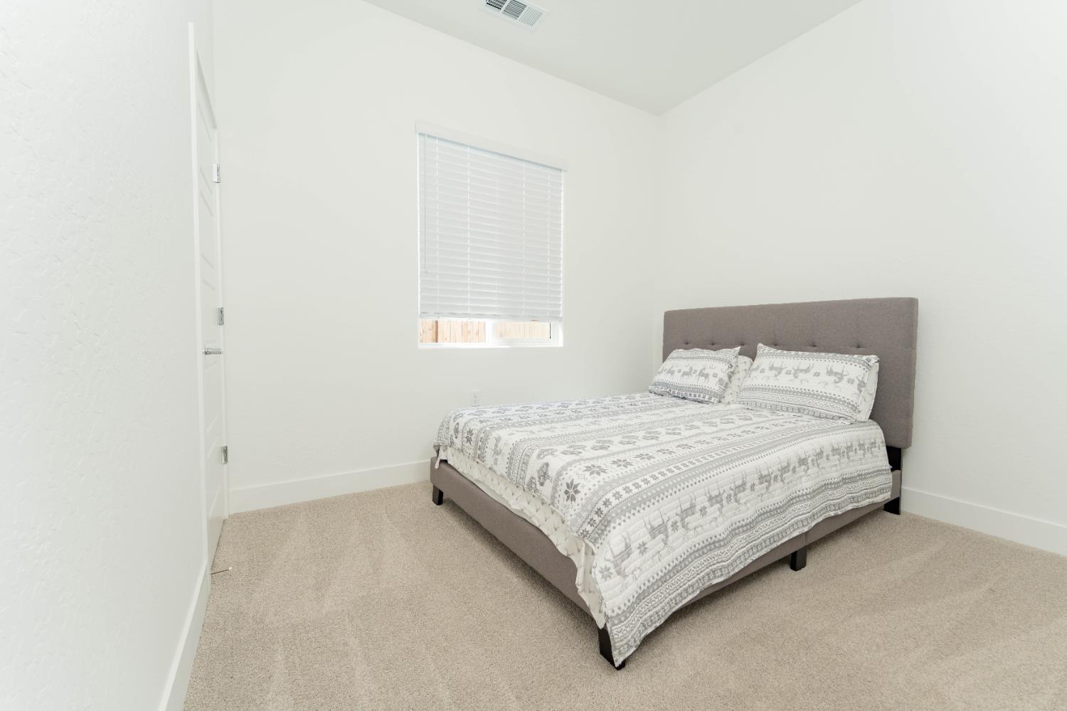3811 North Santa Fe Street Visalia, CA 93291 - Photo 19 of 23 a bedroom with a bed and window