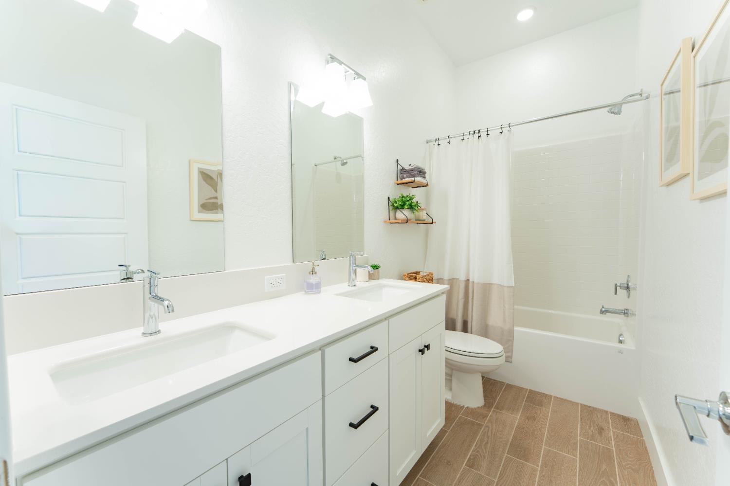 3811 North Santa Fe Street Visalia, CA 93291 - Photo 20 of 23 a bathroom with a sink a toilet and shower