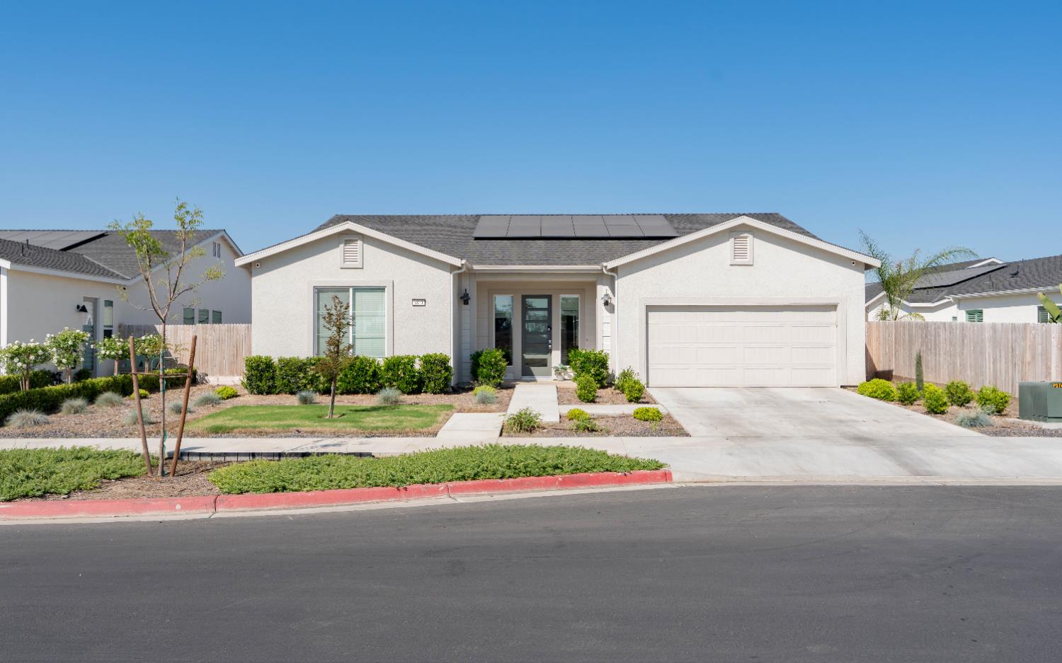 3811 North Santa Fe Street Visalia, CA 93291 - Photo 2 of 23 a front view of a house with a yard and garage
