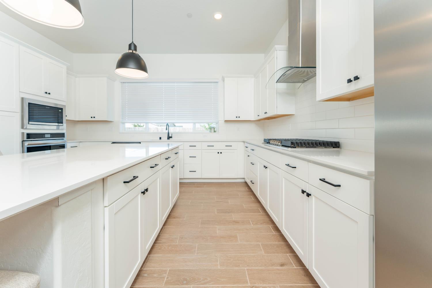 3811 North Santa Fe Street Visalia, CA 93291 - Photo 10 of 23 a kitchen with granite countertop white cabinets and white appliances
