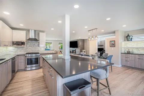a kitchen with center island table and chairs