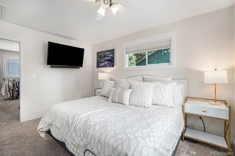 a bed sitting in a bedroom next to a window