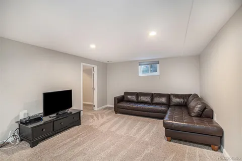 a living room with a bed furniture and a window