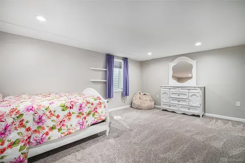 a spacious bedroom with a bed and a window