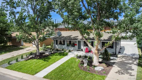 an aerial view of a house with swimming pool and garden