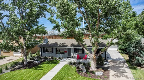 aerial view of a house with table and chairs under an umbrella