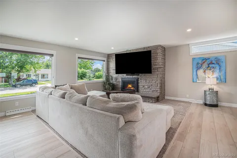 a living room with furniture a large window and a flat screen tv