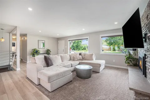 a living room with furniture and wooden floor