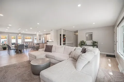 a kitchen with a refrigerator and white cabinets