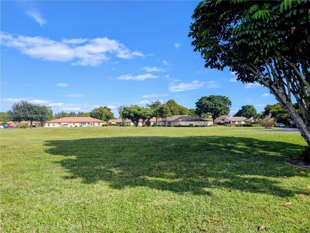 a view of outdoor space with green field and trees