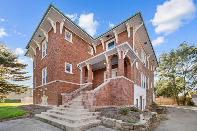 a front view of a residential apartment building with a yard