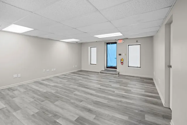 a view of empty room with wooden floor