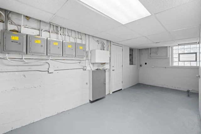 a view of storage and utility room with window and racks