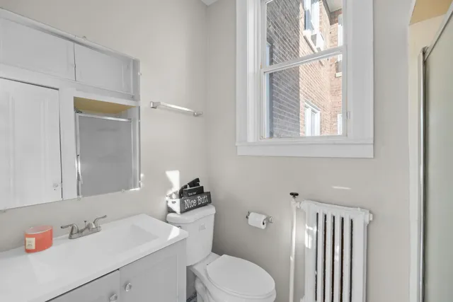 a bathroom with a sink toilet and mirror