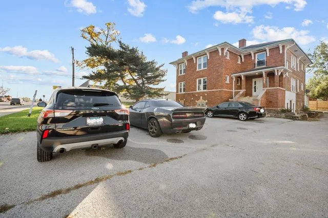 a car parked in front of a white house