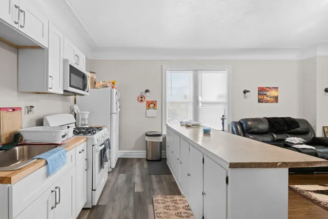 a kitchen with a sink a stove and cabinets