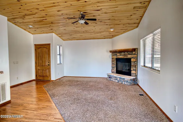 a view of an empty room with a fireplace